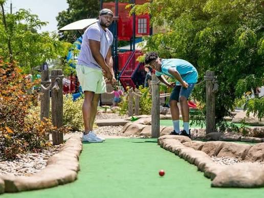 Family playing mini golf
