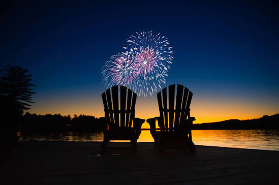 Muskoka chairs beneath fireworks