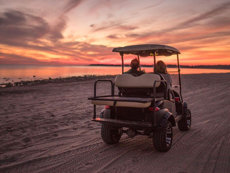 Sunset golf cart ride along the shore
